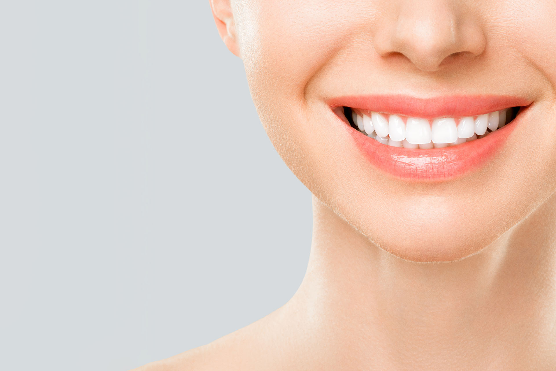 Perfect white teeth smile of a young woman. The result of the teeth whitening procedure. The image symbolizes oral care dentistry, Closeup on a white background. Sbiancamento Dentale Reggio Emilia